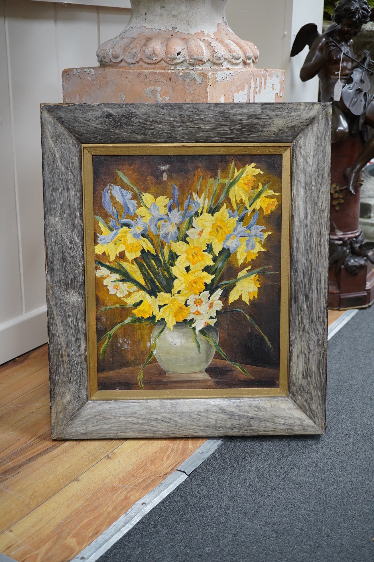 20th century oil on canvas, Still life of daffodils in a vase, indistinctly signed, 47 x 37cm, unframed. Condition - poor to fair